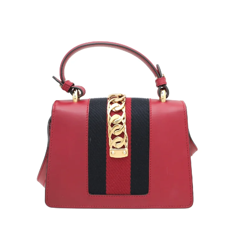 Women Gucci Sylvie bags with a crystal - embellished web stripeGucci Red Sylvie Top Handle Mini Bag