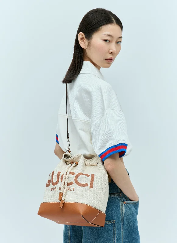 Women Gucci Sylvie bags featuring the signature web stripeGucci Women Logo Print Drawstring Shoulder Bag